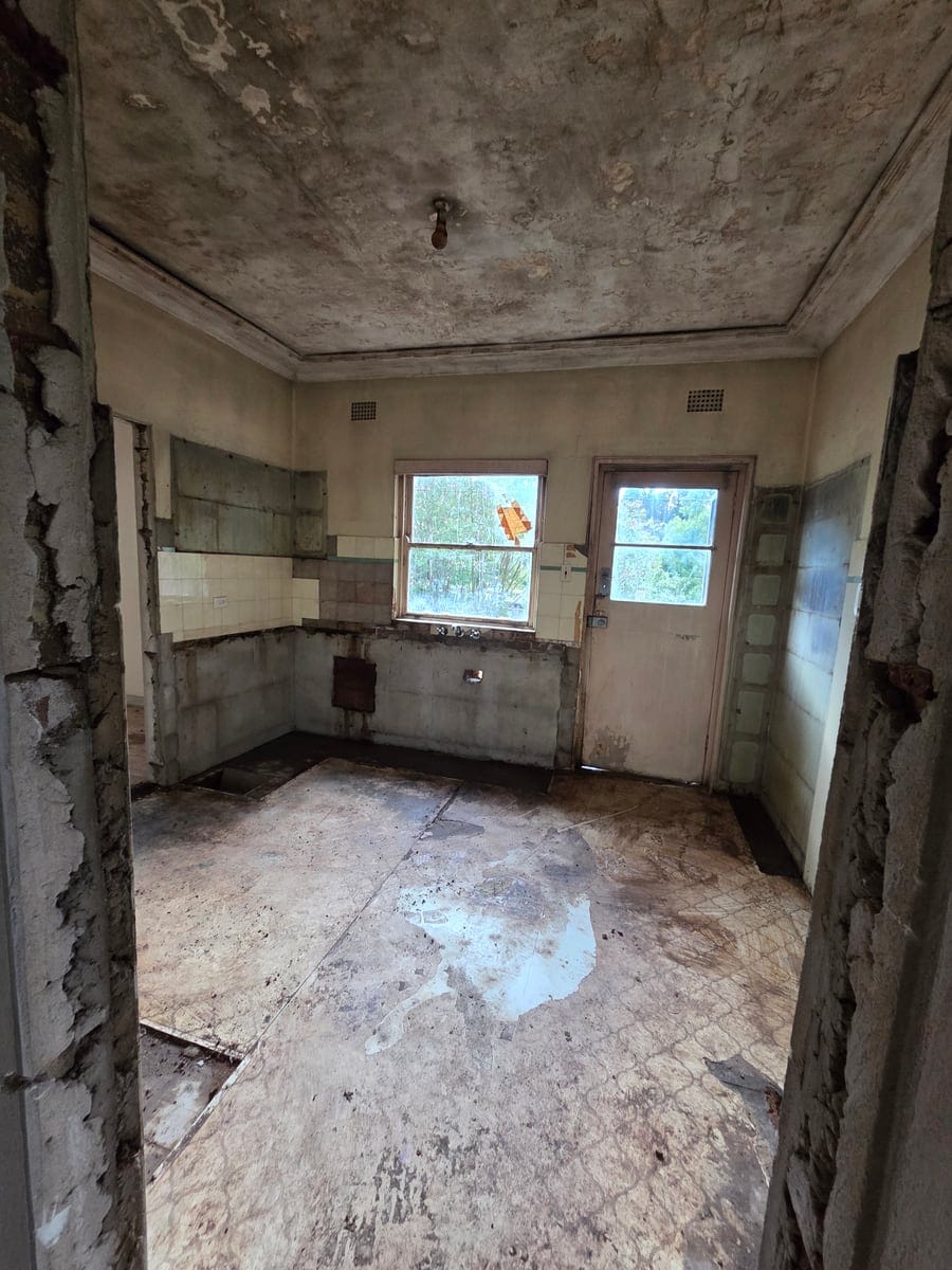 Rotted kitchen and wall linings completely stripped out back to timber framing and clean floorboards